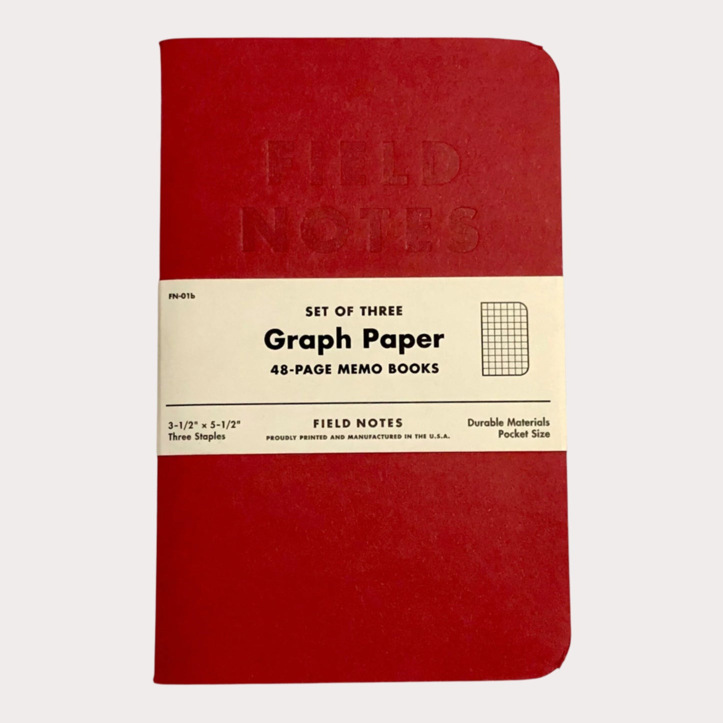 Set of three Field Notes graph paper memo books with red cover and beige label on a white background