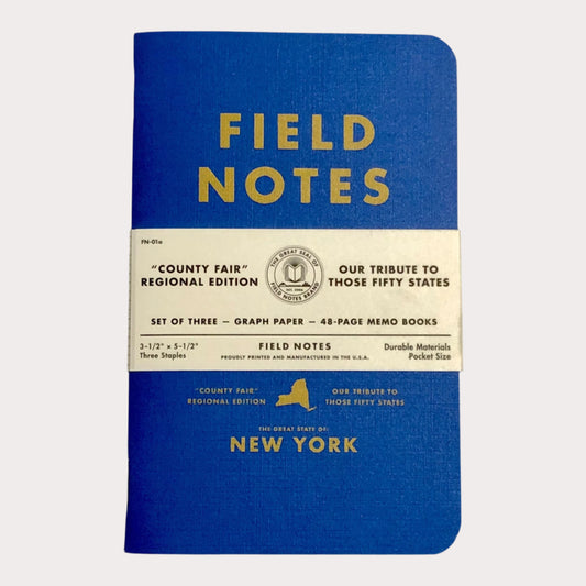 Blue notebook with 'Field Notes' branding on a light gray background