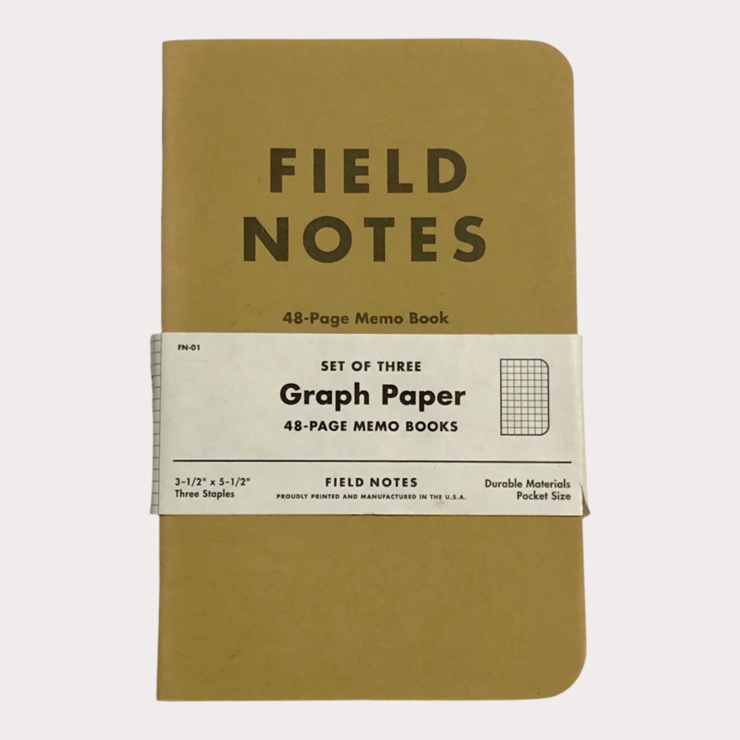 Set of three Field Notes graph paper memo books on a light gray background