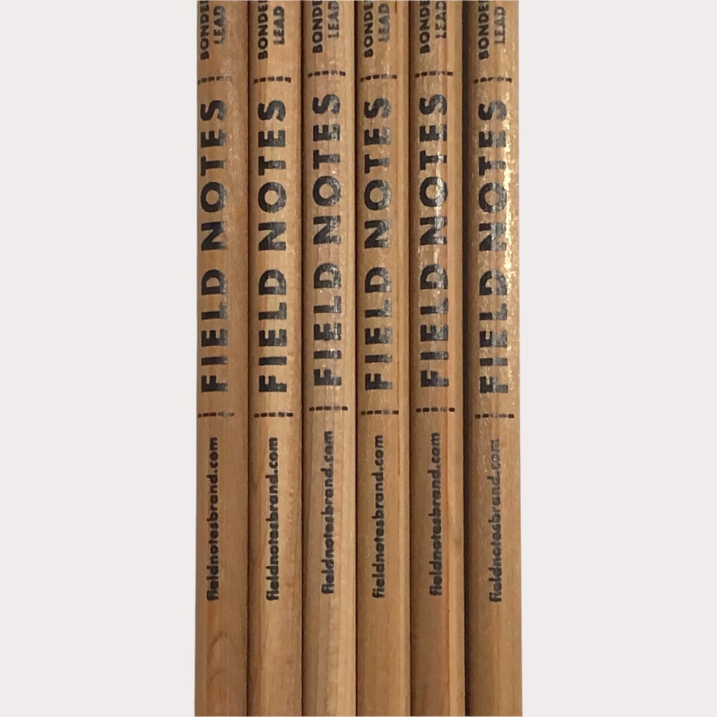 Set of wooden pencils with 'Field Notes' branding on a white background