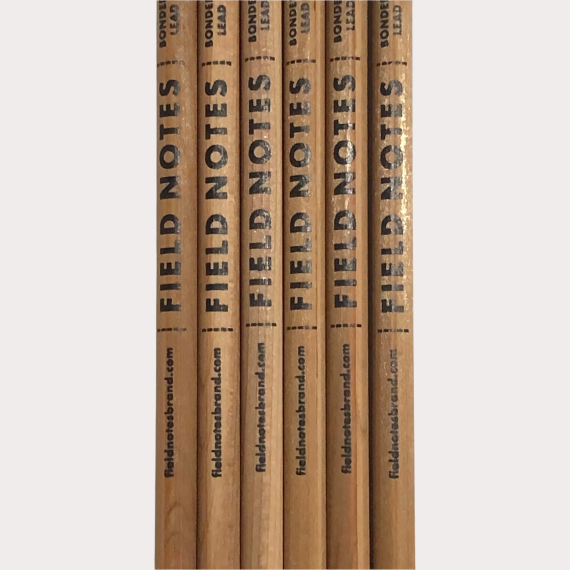 Set of wooden pencils with 'Field Notes' branding on a white background