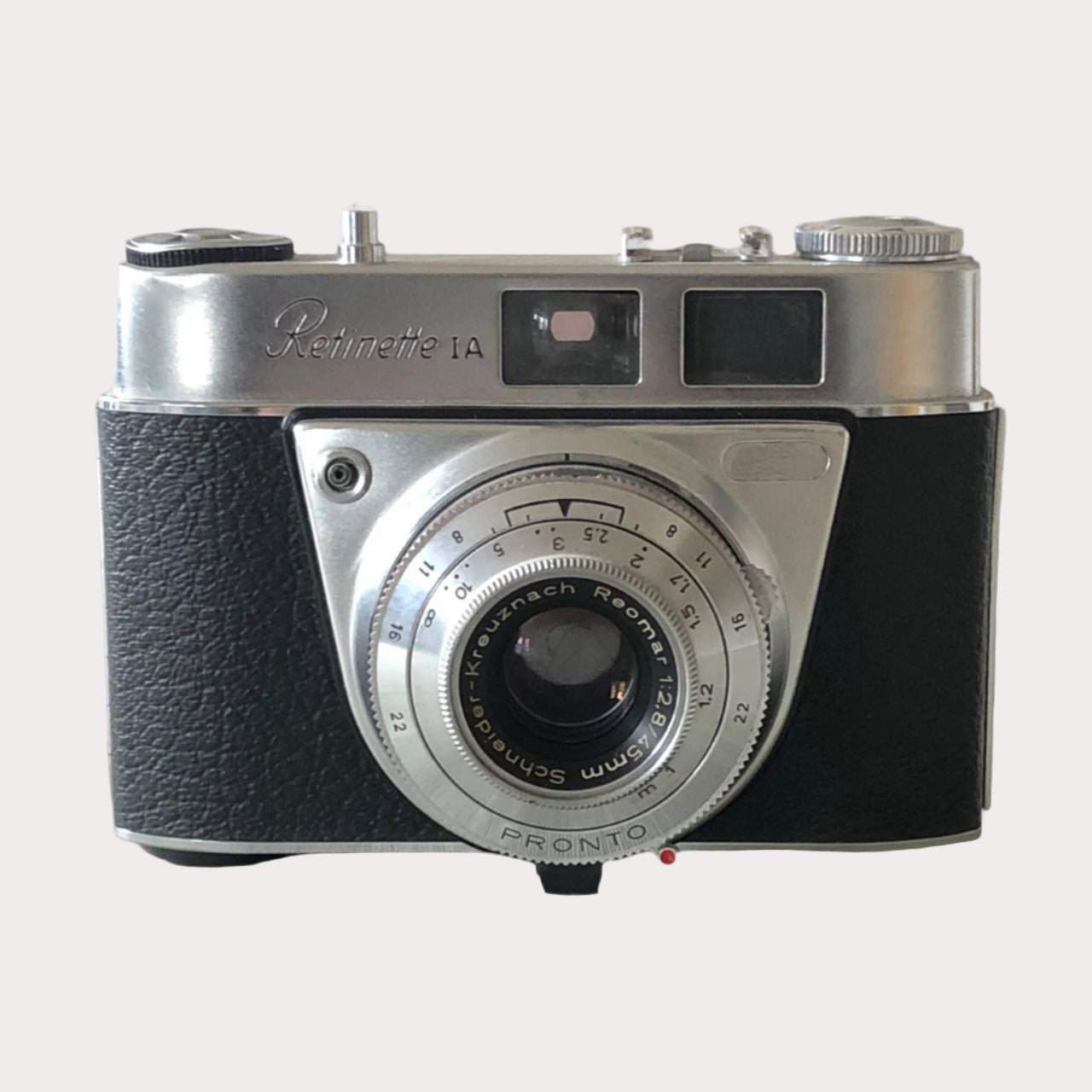 A pre-owned Retinette 1A Pronto film camera with a black leather exterior and a visible lens.