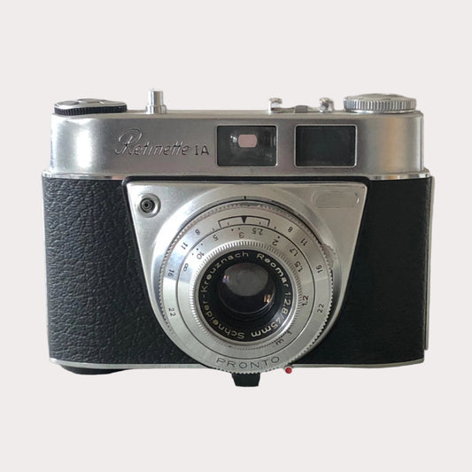 A pre-owned Retinette 1A Pronto film camera with a black leather exterior and a visible lens.