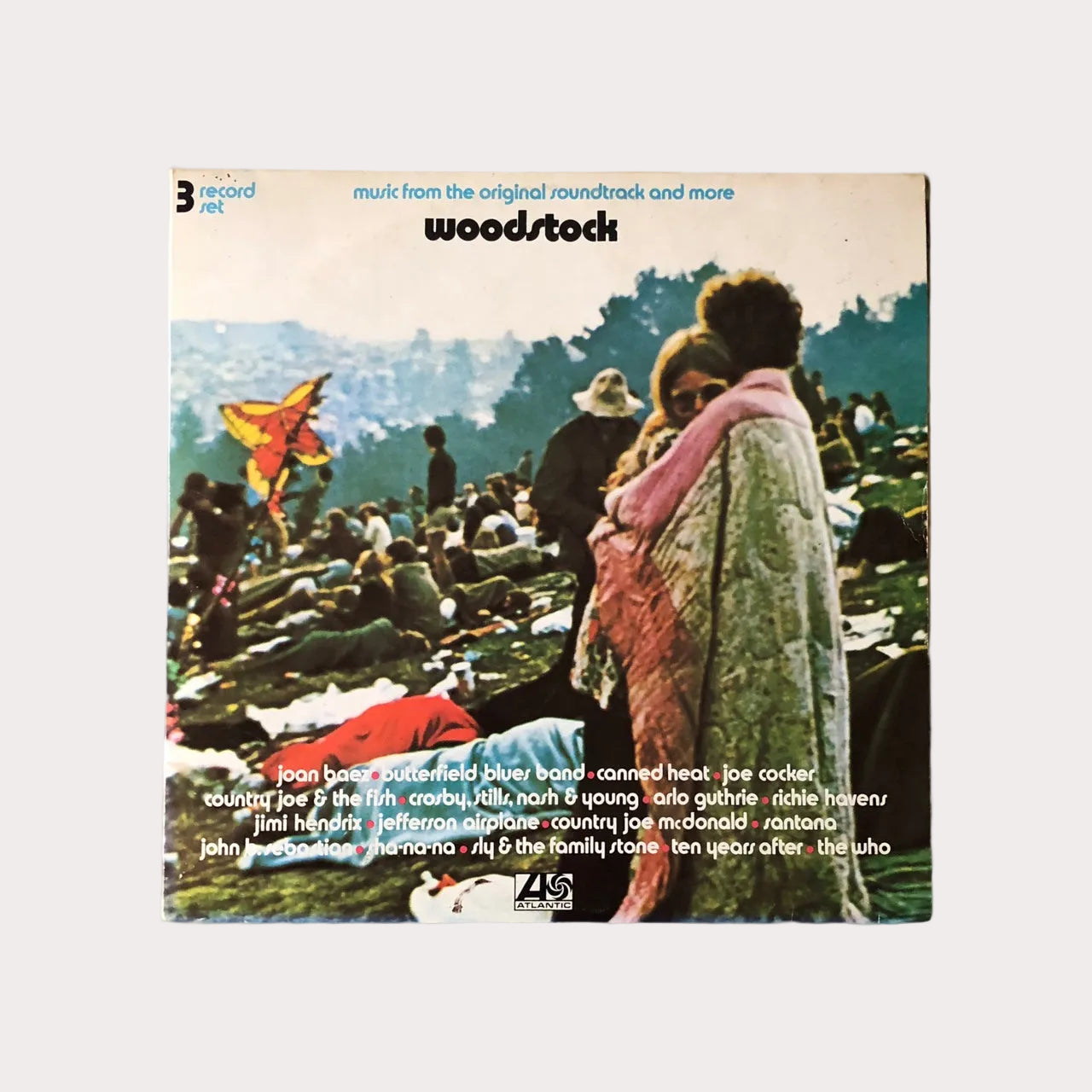 Vintage Woodstock album cover featuring photographs from the original Woodstock festival, with the band and crowd in the background.